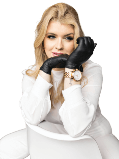 Image of a beauty professional sitting, with a focus on her hands wearing a pair of black gloves. The gloves symbolize the dedication and care that beauty professionals provide to their clients.